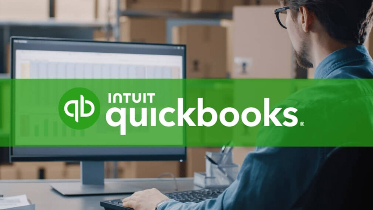 QuickBooks accounting software interface displayed on a desktop monitor with a business workspace.